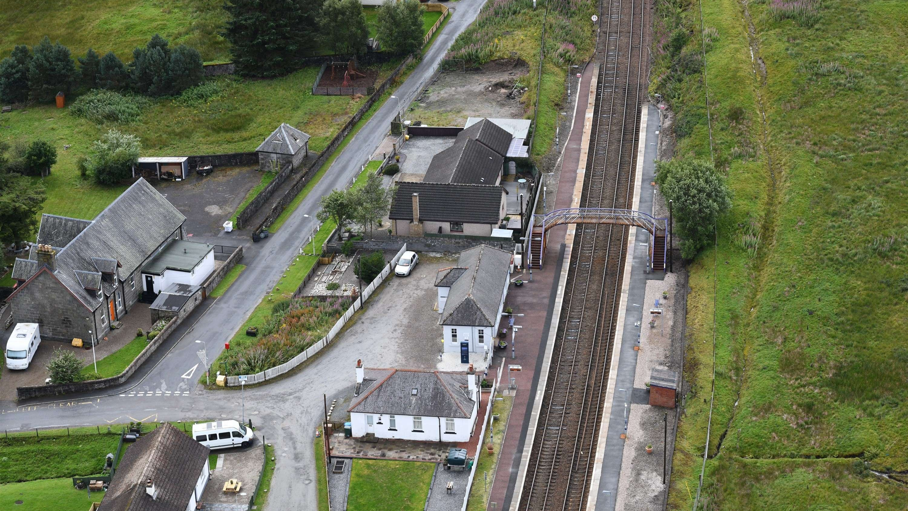 Railway track and signals on a rural double-track line in the Scottish Highlands