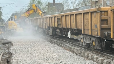 Rail engineers replacing track and ballast on a closed railway line